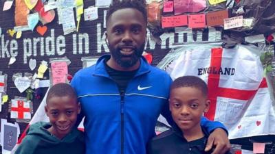 Father with his two sons at mural