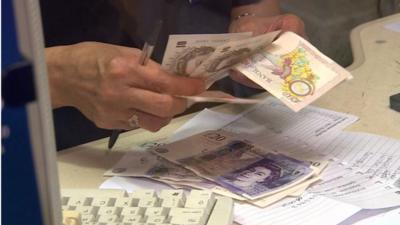 Bank cashier counting out money