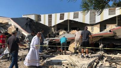 People trying to find others in the rubble