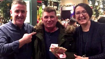 Pub managers Mick Dore and his wife Sarah, with Mariusz in the middle