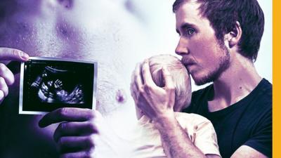 Freddy McConnell holding his baby and pregnancy scan