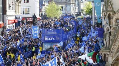 Leicester City celebrate with the trophy on the bus during the parade