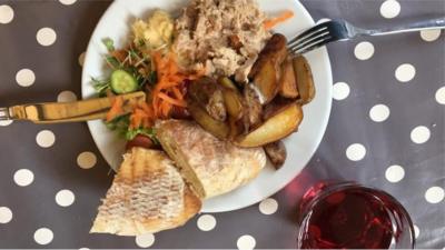 Demand is so high at a cafe that sells unwanted food, that customers queue for up to two hours.