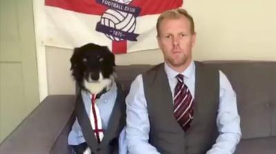 A man and a dog in waistcoats