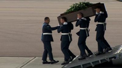 Coffin of Tunisia victim carried by military personnel