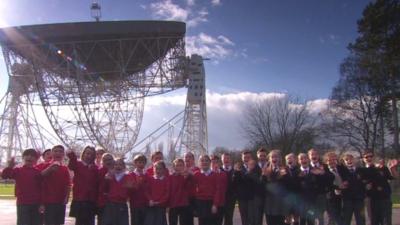 Children at Jodrell Bank waving