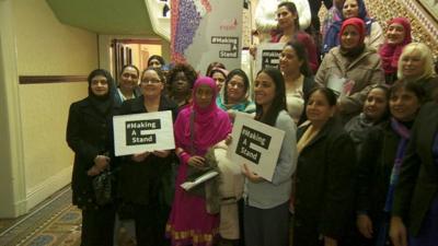 Group of women with signs saying '#makingastand