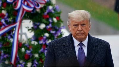 President Trump stands in front of wreath at Arlington Cemetery