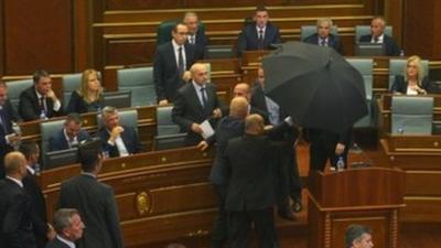 Prime Minister protected by umbrella