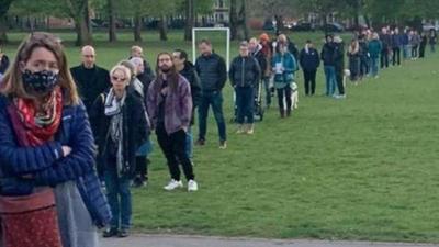 people queuing to vote