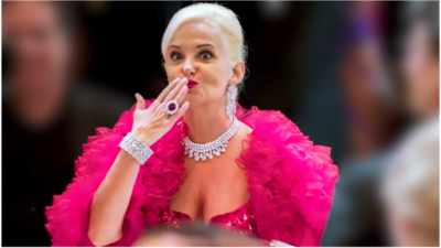 Woman in a bright pink dress with pink frills.