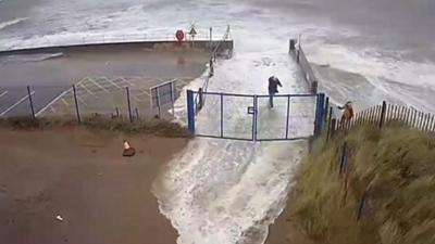 Three people almost get caught in a wave