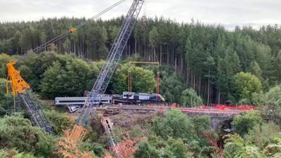 Lifting begins to remove carriages from the track near Stonehaven