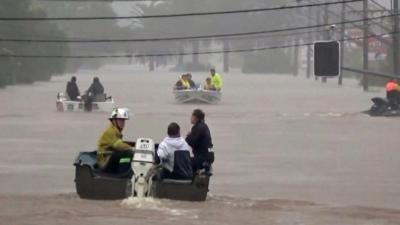 Boats perform resue in flooded street