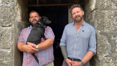 Shaun Ferkin and Peter Warrington standing in a door way at their farm in Redruth