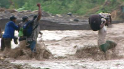 People in flood water in Haiti