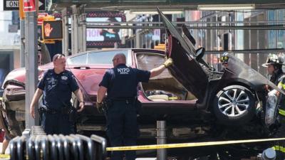 Car rests on its side following Times Square crash