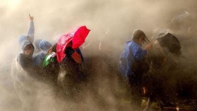 Demonstrators are hit by water cannons of the police as they protest on July 7, 2017 in Hamburg, northern Germany