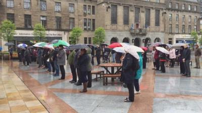 People in Dundee observe the minute's silence