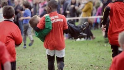 Boy helps friend