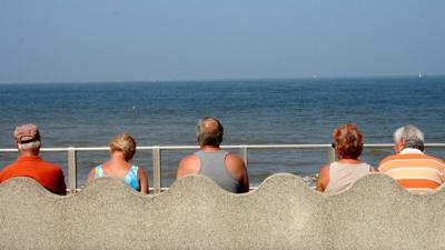 Older people sitting by the sea