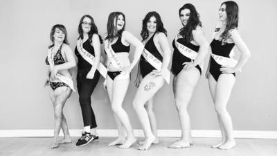 A line of pageant contestants posing