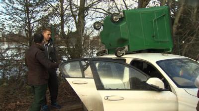 Carlisle United goalkeeper Dan Hanford finds his car under a bin after flooding caused by Storm Desmond