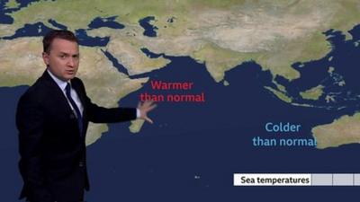 Matt Taylor with explanatory map of sea conditions