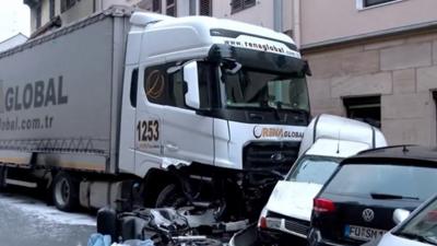 A truck with a van jammed in front of it.