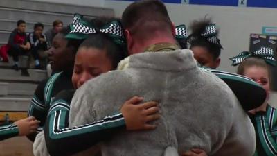 Daughters hug their father