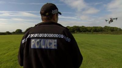 Police officer operating drone