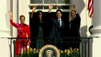 The Obamas and the Trudeaus wave from the Truman Balcony of the White House