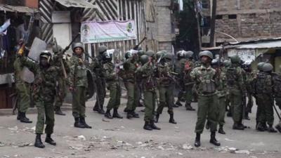 Police and supporters of defeated opposition candidate Raila Odinga confront each other in Mathare.