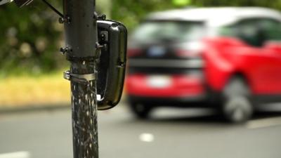 A car being captured by a licence plate reading camera