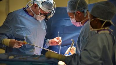 Surgeons performing an operation.