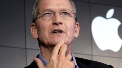 Tim Cook next to Apple logo