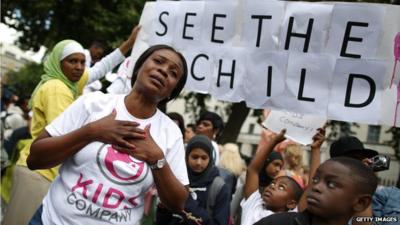 A member of staff from Kids Company taking part in a protest march near Downing Street