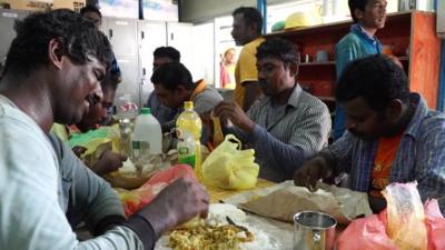 Men eating rice