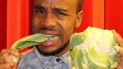 BBC Newsbeat reporter Nesta McGregor eating a cauliflower