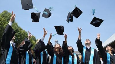 Students throwing hats in air