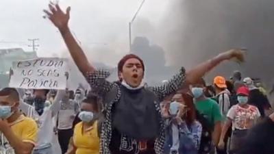 A man waving his arms at a Colombian protest.