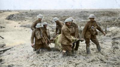 Colourised image of stretcher bearers in the mud of Passchendaele in 1917