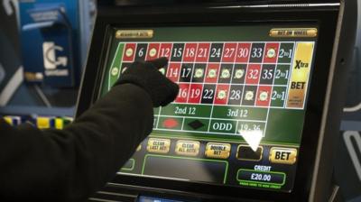 A gambler playing on a machine