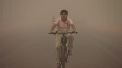 A boy rides a bike in Delhi, India