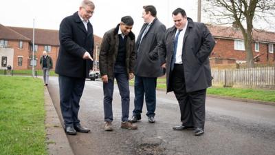 Prime Minister Rishi Sunak looking at a pothole in Darlington with council leader Jonathan Dulston (far right), Tees Valley Mayor Ben Houchen (second from right) and Darlington MP Peter Gibson (far left)