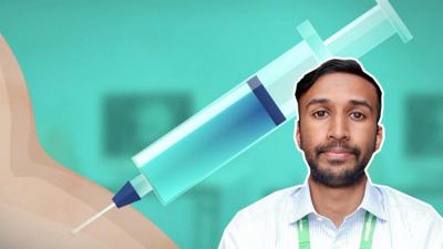 Dr Venughanan Manikavasagar in front of a vaccine graphic