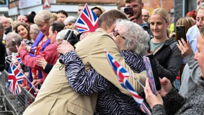 Prince William hugs an elderly woman in east Belfast