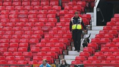 A sniffer dog patrols the stands at prior to match being abandoned with fans evacuated from the ground prior match between Manchester United and AFC Bournemouth at Old Trafford