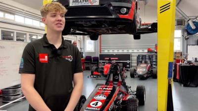 Staffordshire University Racing Team leader Joe Grimer standing in front of racing car