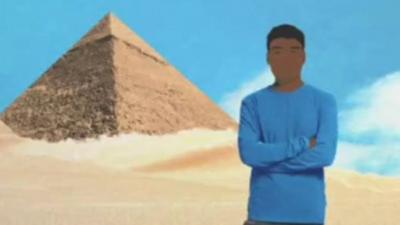 Hisham standing in front of the Pyramids